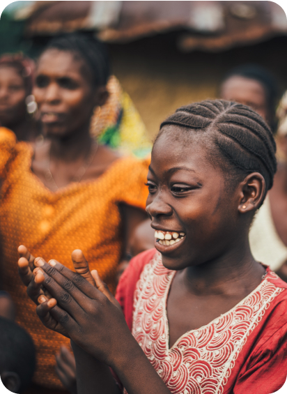 African woman smiling and clapping her hands