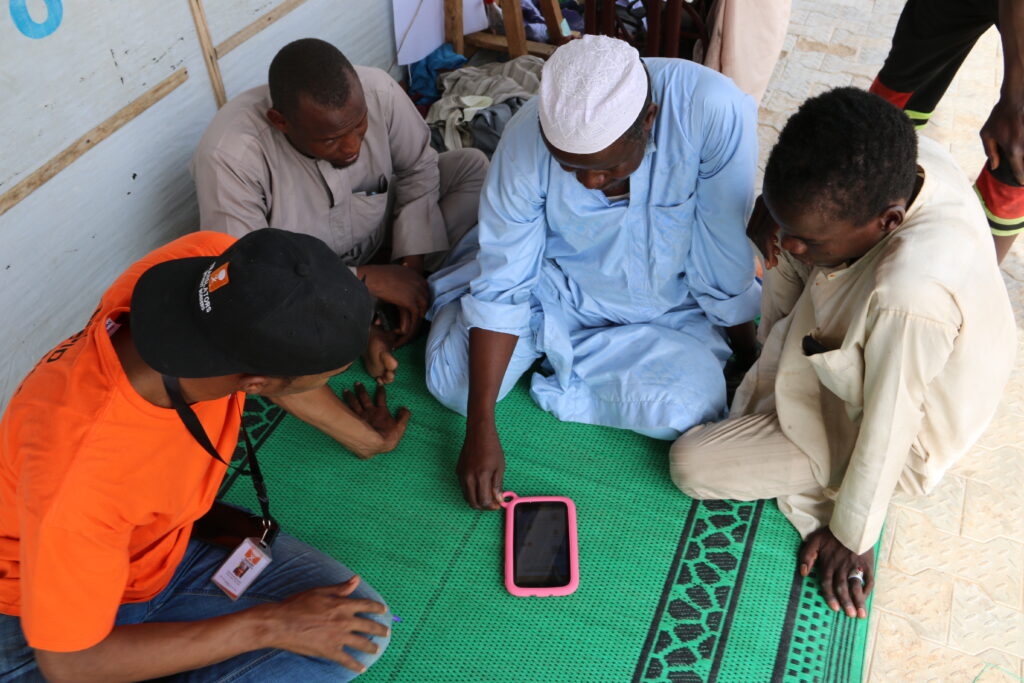 A group of people using Internet in a box, in Gubio northeast Nigeria, Nov 2019