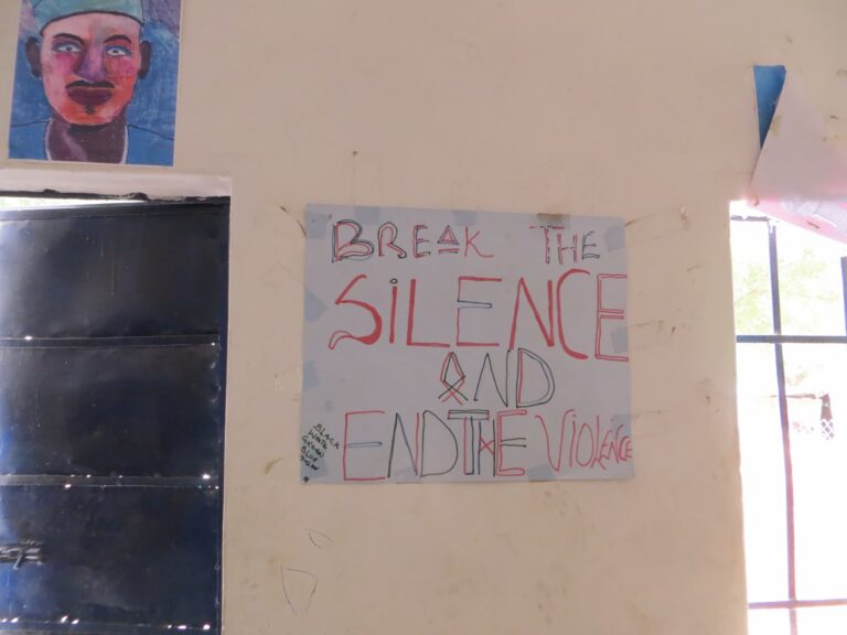 A child's poster in Bama, Nigeria during a field trip talking about protection with community members