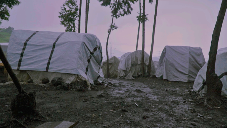 Kanyaruchinya camp, DRC, shelters and trees at sunset